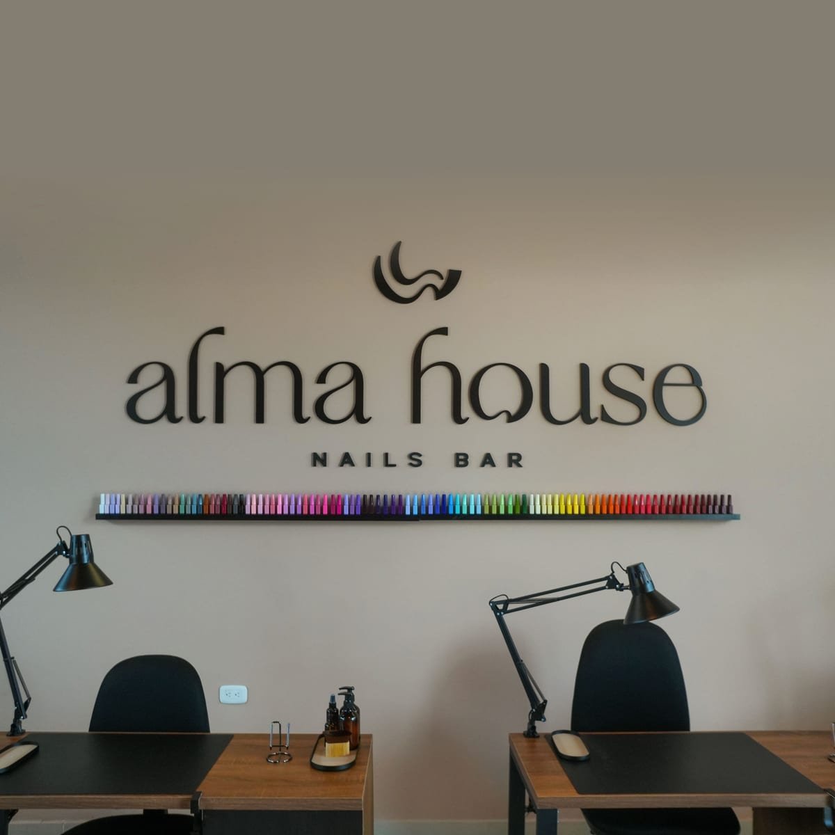 Clienta disfrutando su cita de manicure en Alma House, con un café en la mano